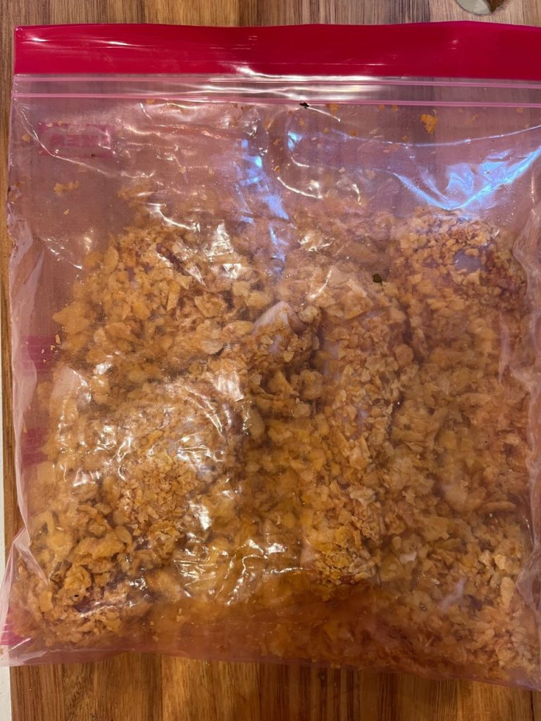 Drumsticks coated in crushed cornflakes inside the zip-lock bag