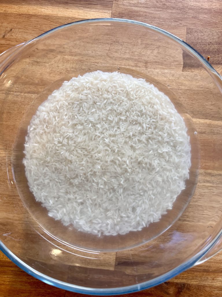 Rinsed long-grain rice in a microwave-proof bowl, ready to be cooked with water
