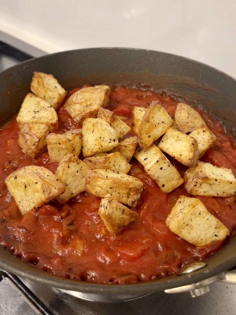 Crispy air-fried potatoes added to the tomato mixture