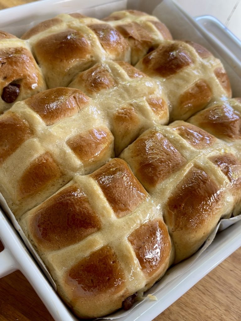 Hot cross buns brushed with sugar syrup for a glossy finish