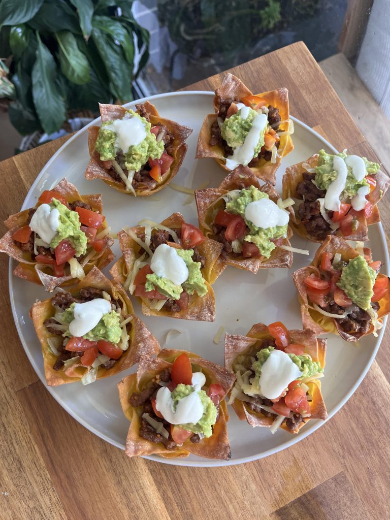 Overhead shot of colourful taco cups with crunchy wonton shells and vibrant fresh toppings