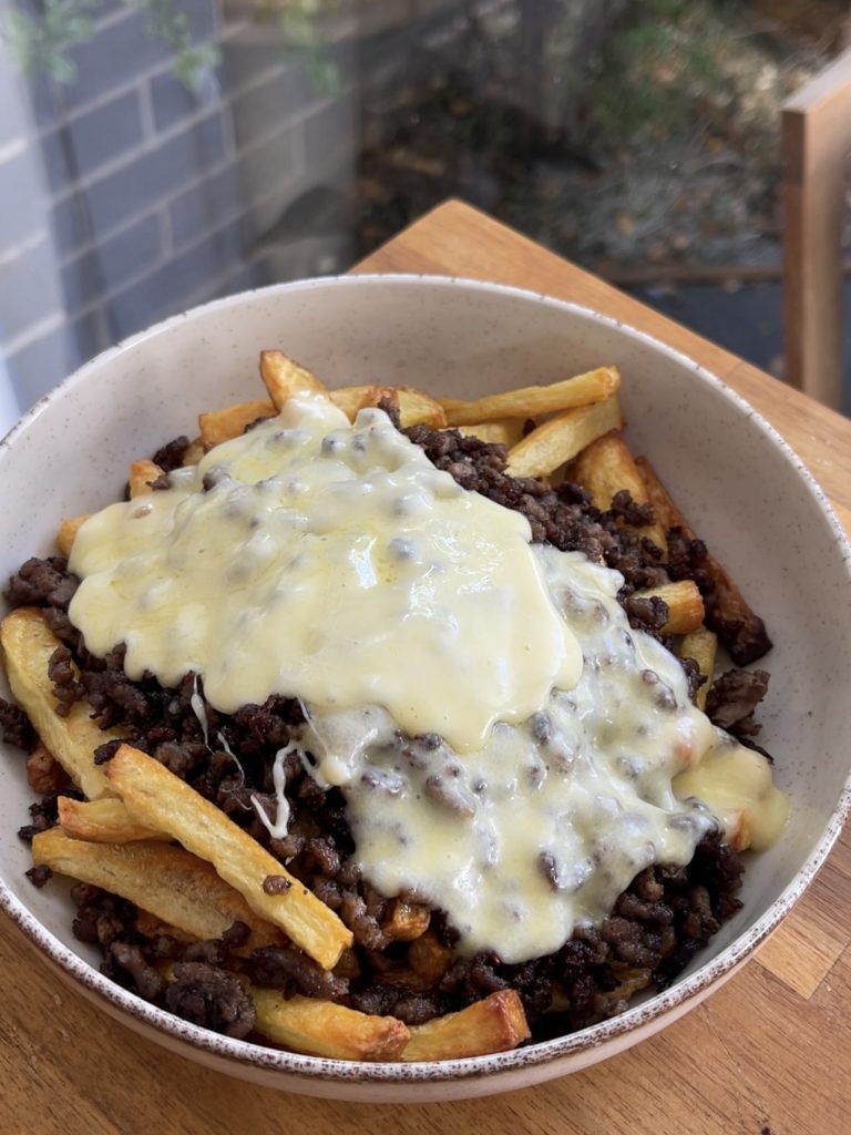 Melted burger cheese and milk whisked into a creamy sauce poured over the beef and fries