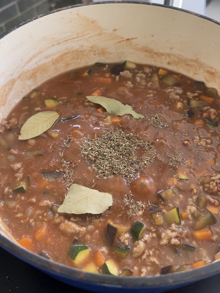 Red wine, beef stock, Worcestershire sauce, thyme, and bay leaves simmering into a rich gravy